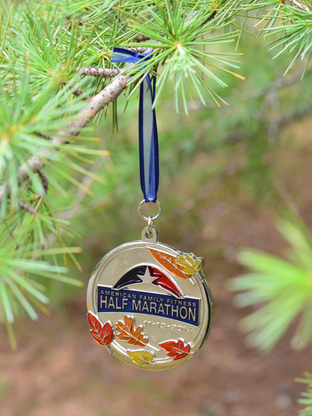 half marathon running race medal hung on christmas tree