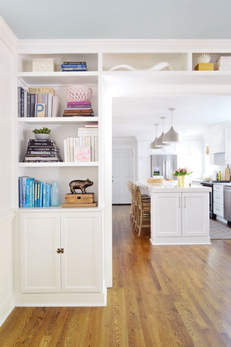 built-in bookshelves in opening to kitchen
