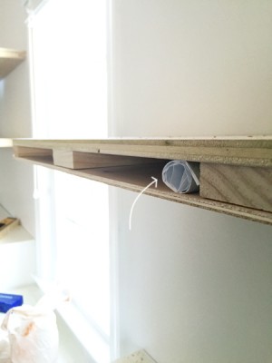 secret note placed within DIY floating shelves during construction for discovery later as a time capsule