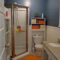 A Dark Blue Bathroom With A Corner Shower