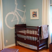 A Blue Nursery With A Bike Mural