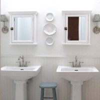 A Luxe White Bathroom With Pedestal Sinks