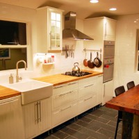 A White Kitchen With Butcher Block And An Apron Sink