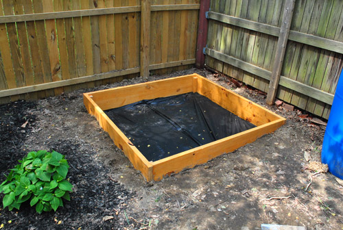 Image of Wooden tractor planter with sandbox attached to the back