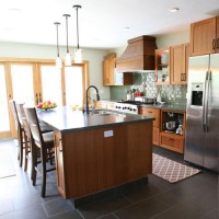 A Kitchen With Wood Cabinets & Sage Green Tile