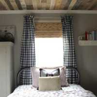 A Boy’s Bedroom With A Wood Plank Ceiling & Checkered Curtains