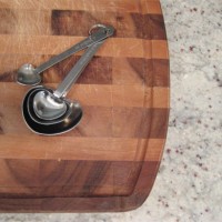 Heart shaped Measuring Spoons On Wood Cutting Board