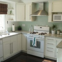 A White Kitchen With Green Glass Mosaic Backsplash Tile