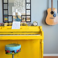 Bright Yellow Painted Piano With Music Room With Guitar