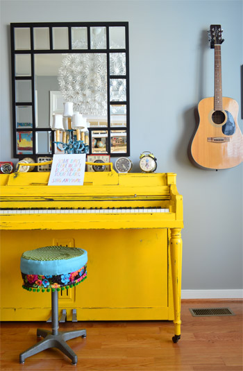 Bright Yellow Painted Piano With Music Room With Guitar