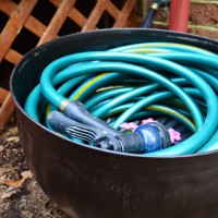 Garden Hose Coiled Into Bronze Hose Pot