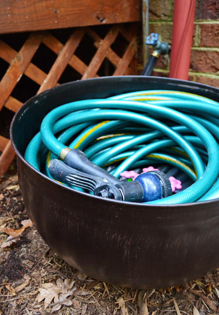 Garden Hose Coiled Into Bronze Hose Pot