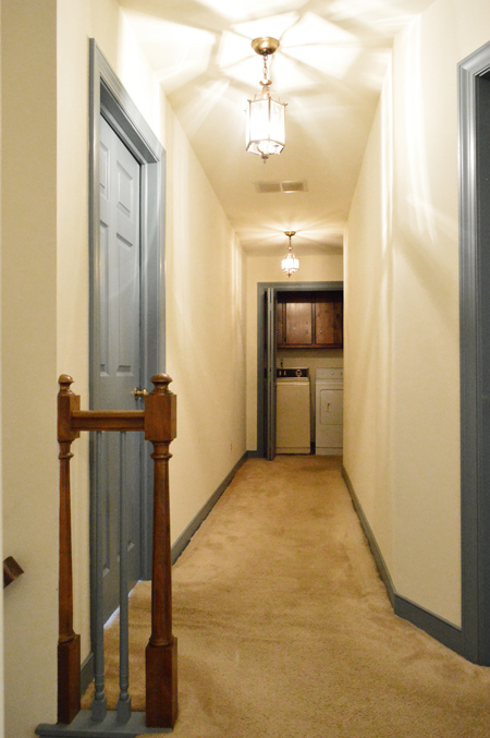 Before Photo Of Hallway With Carpet And Blue Trim Looking Toward Laundry Room