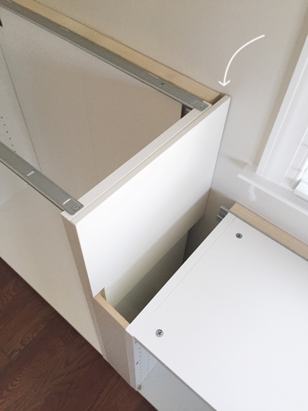 white cabinet filler pieces used to cover exposed side of Ikea cabinet installation