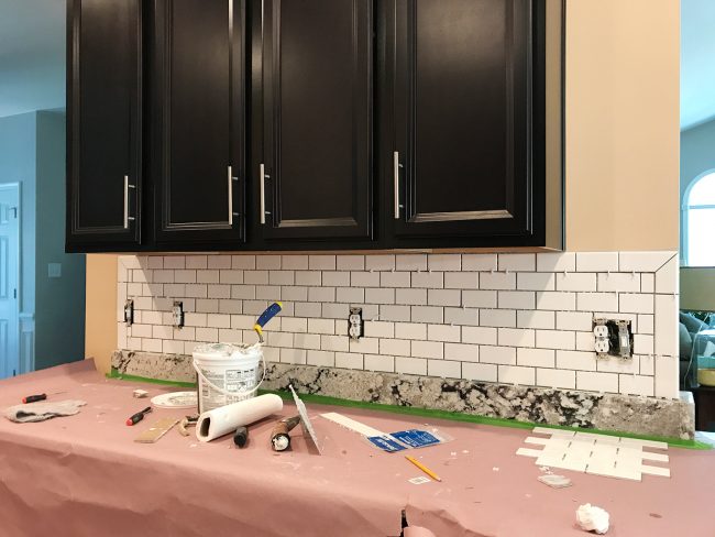 ungrouted white subway tile backsplash with bullnose edges