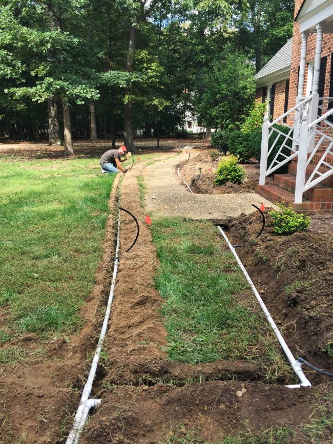 install irrigation system pipe along walkway