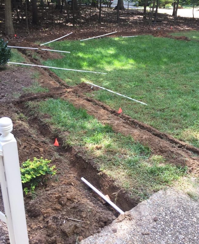 install irrigation system laying pvc pipe along trenches