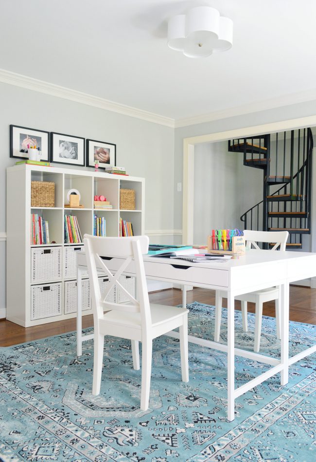 homework room decorating with blue rug and lots of objects on walls and table