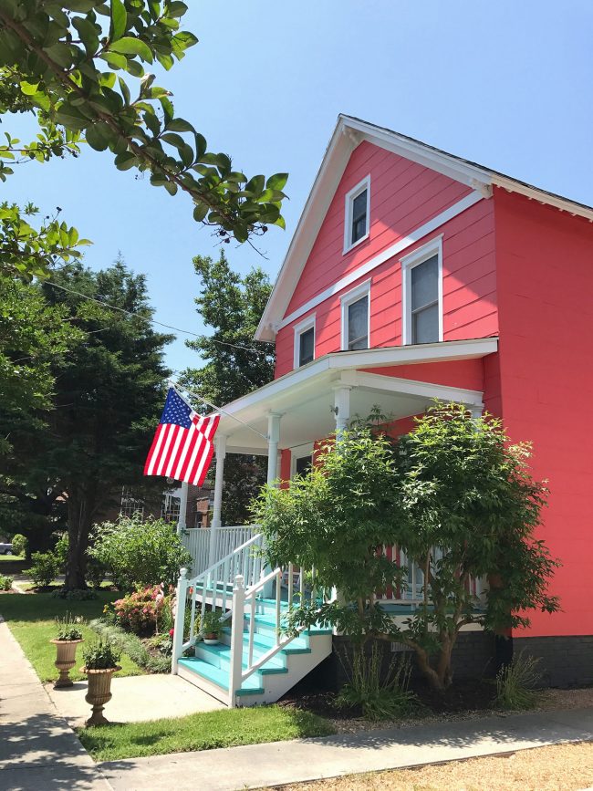 patriotic front porch bright pink house blue porch stairs