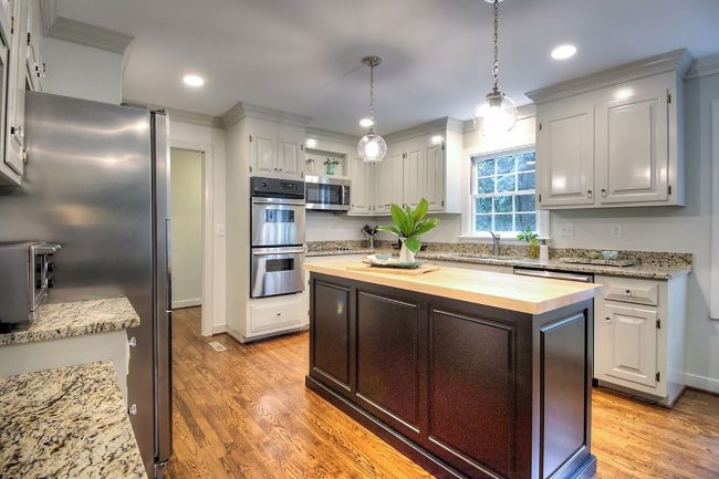 kitchen staged to sell by removing items on counters and refrigerator