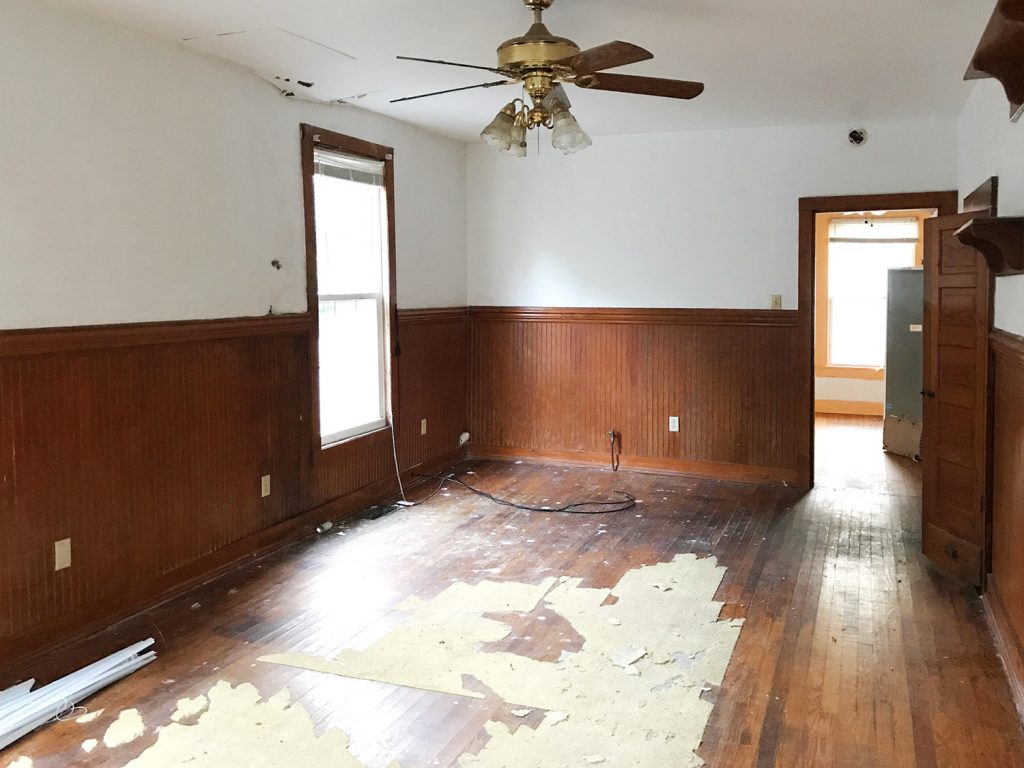 Before Angle Of Dining Room With Ceiling Fan And Dark Paneling