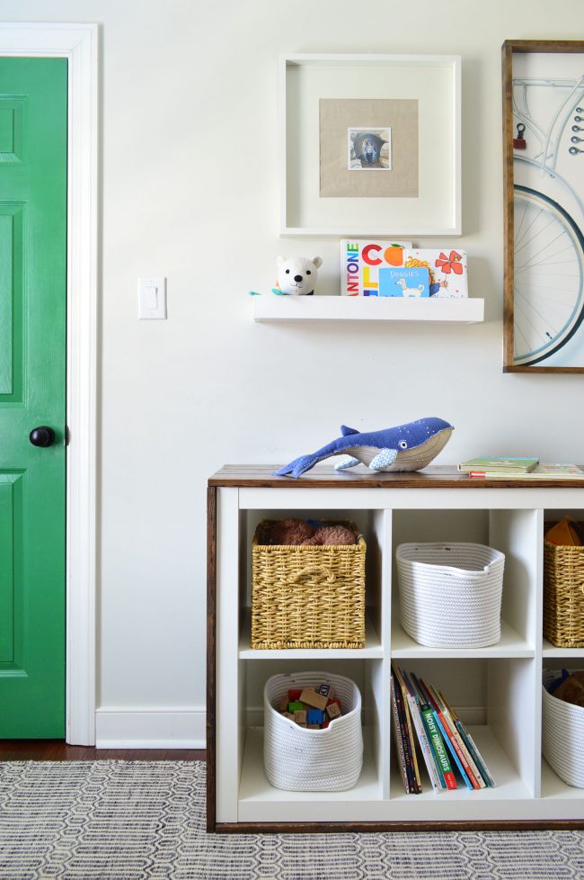 Cube Organizer Bookcase Wrapped In Wood In Boys Bedroom With Green Painted Door