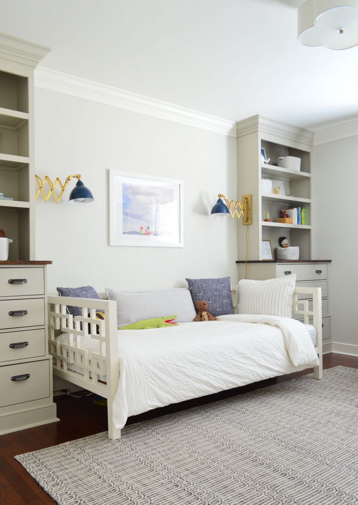 Boys bedroom with built-in bookshelves on either side of the bed,