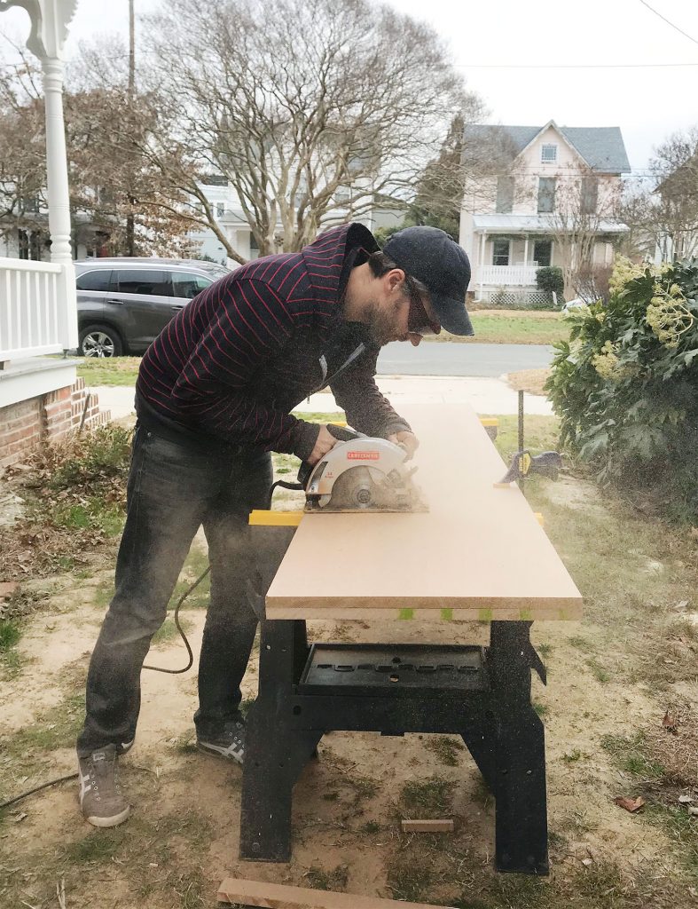 Man cutting MDF using a circular saw