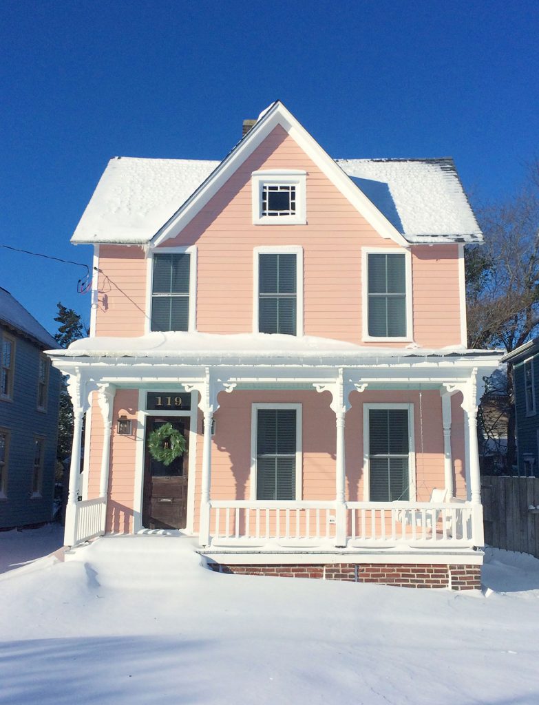 Snow covered historic pink beach house