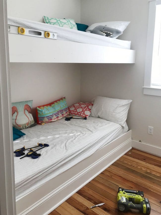 white trim pieces added to the face of bunk bed platforms