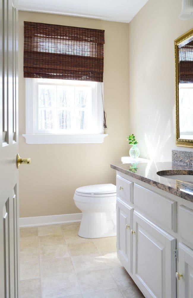 simple clean bathroom staged in house with no bathmat and clean counter