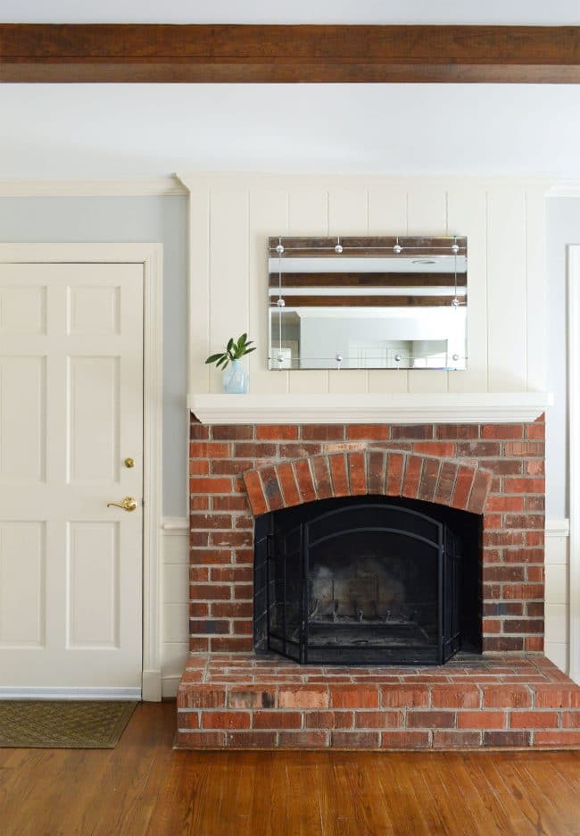 simple fireplace mantle with brick fireplace