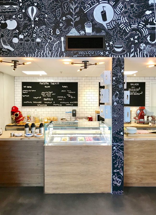 Inside of Bean and Barnacle Gelato with chalk drawings on wall
