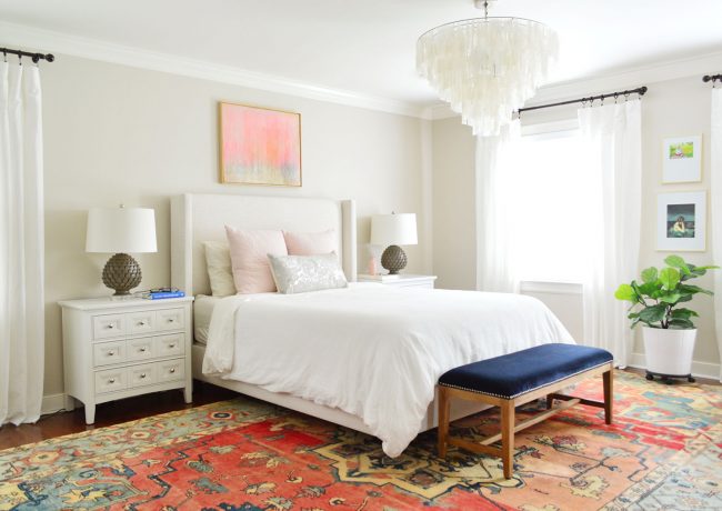 master bedroom with light upholstered bed and white ikea curtains