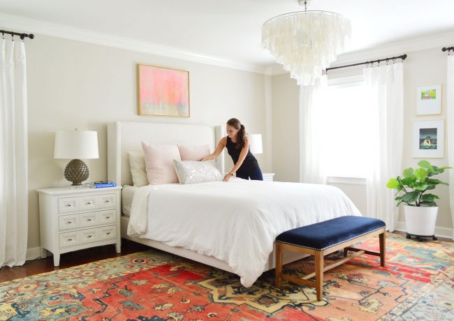 sherry putting pillow on master bed edgecomb gray walls