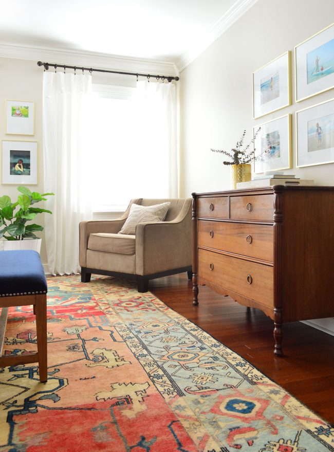 vintage dresser in master bedroom with white curtains