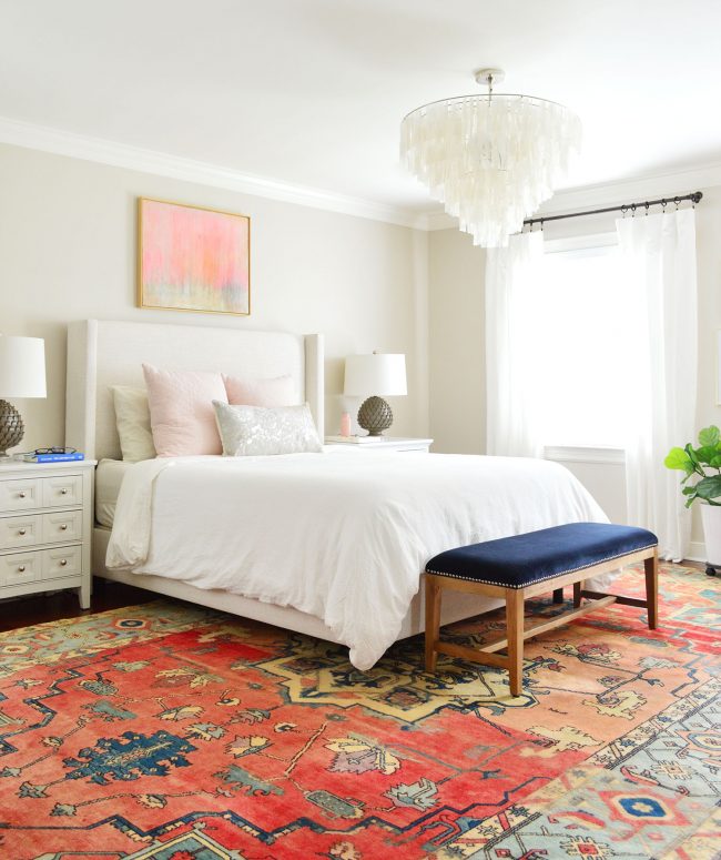 master bedroom with light upholstered bed and white ikea curtains