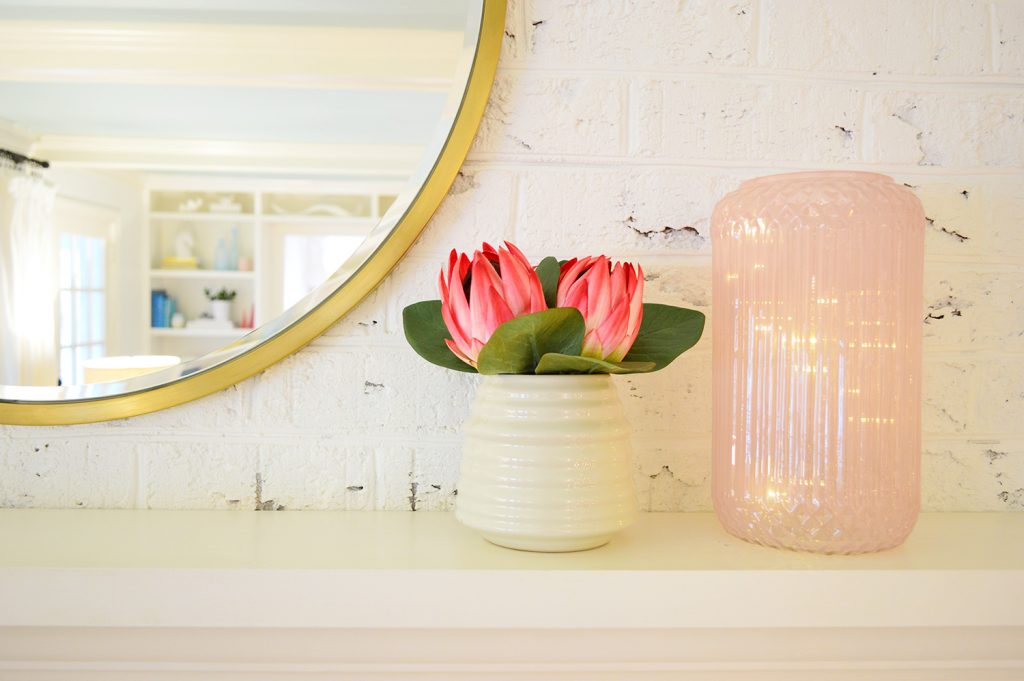 Faux flowers on fireplace mantle in living room