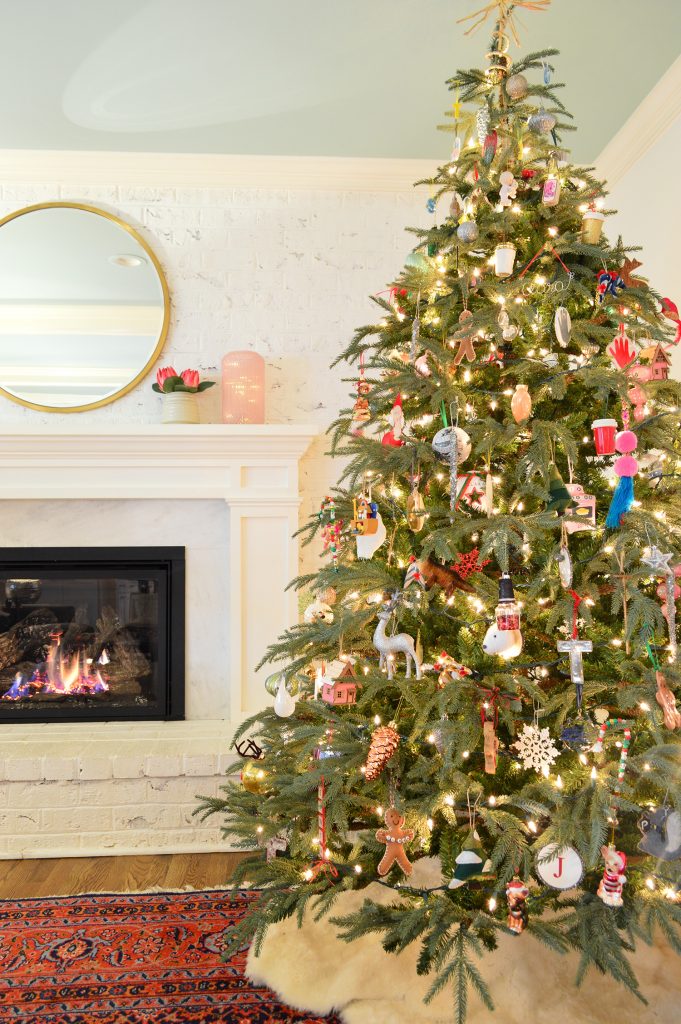 7 foot Faux Christmas Tree On Traditional Rug Next To Gas Fireplace