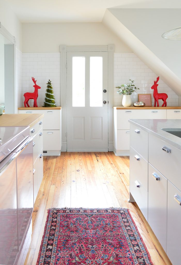 Vintae Kitchen In Beach House With Red Painted Reindeer Flanking Doorway