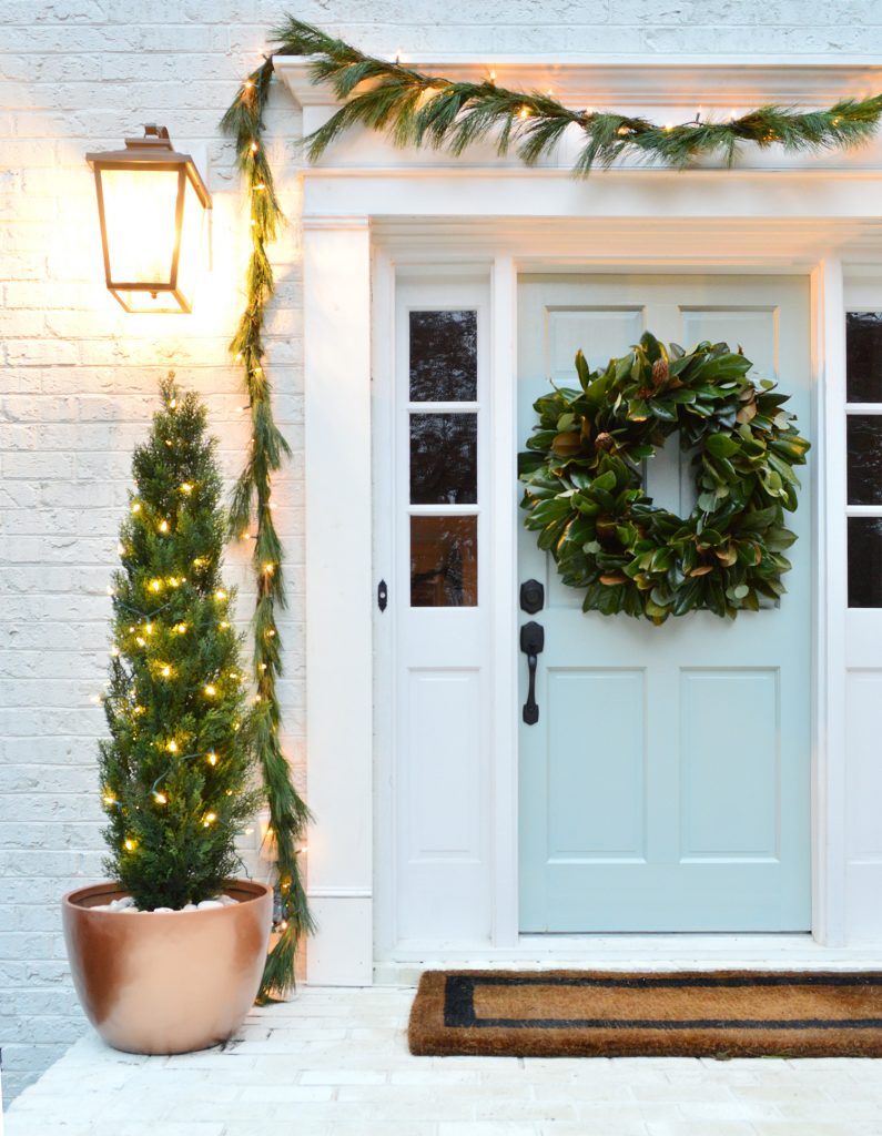 Holiday Front Porch With Magnolia Wreath and Faux Trees In Copper Pots