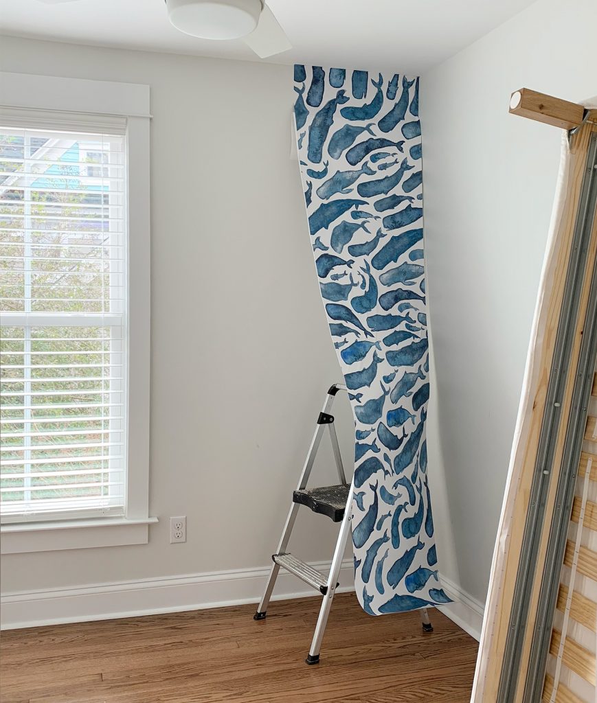One Panel Of Whale Removable Wallpaper Partially Hung In Room
