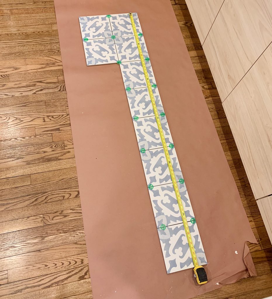 Backsplash Tile Laid On Floor To Determine Length And Pattern