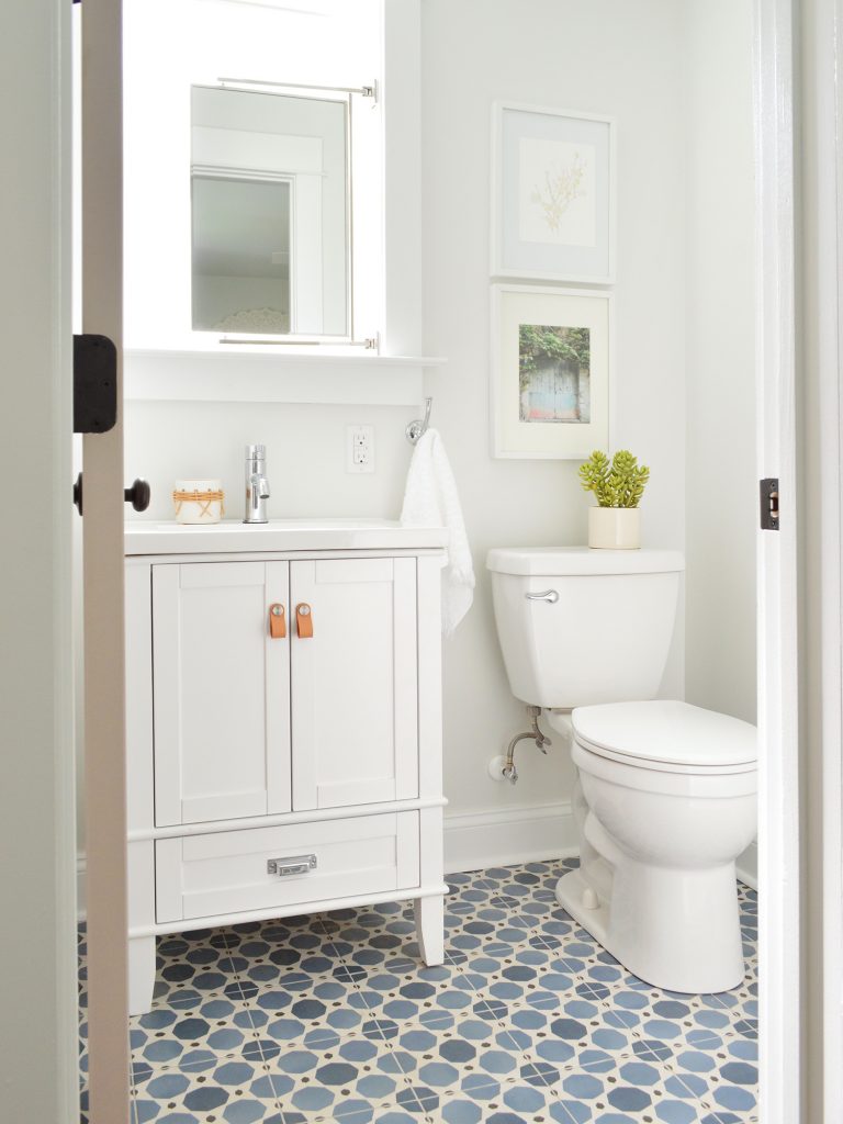 Small Bathroom With Colorful Blue Pattern Tile Floors And White Vanity