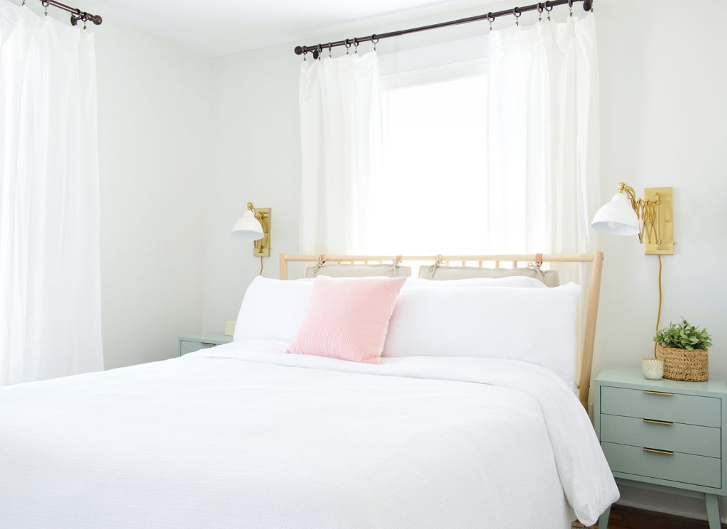 Front Bedroom After With Beachy Wood Headboard And White Bedding And Curtains