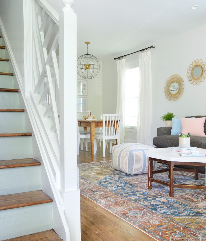 Chippendale Railing In Foreground Of Duplex With Blue Stair Risings