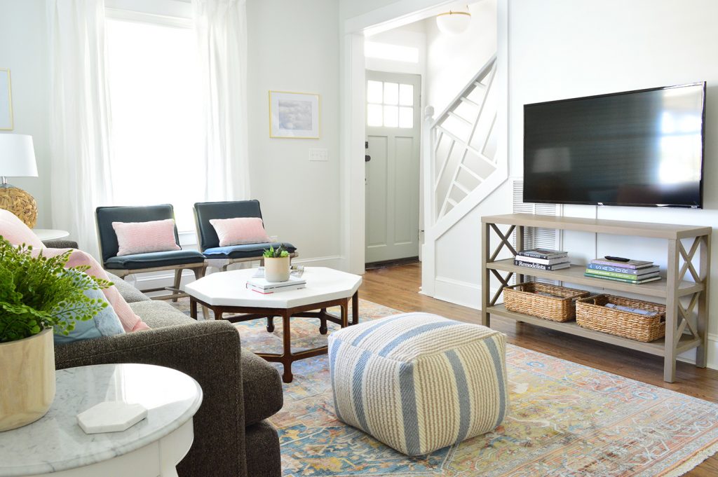 Pouf And Coffee Table In Bright Living Room With Chippendale Railing