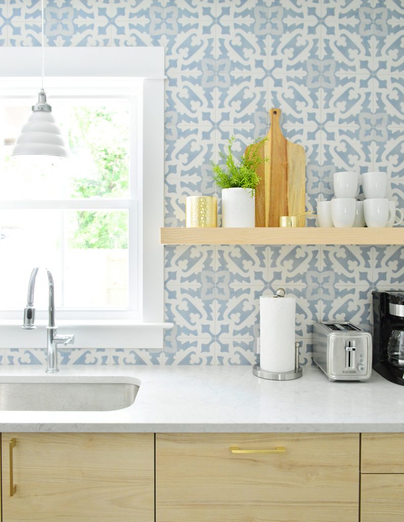 Wood Colored Opened Shelf Against Blue Tile Backsplash