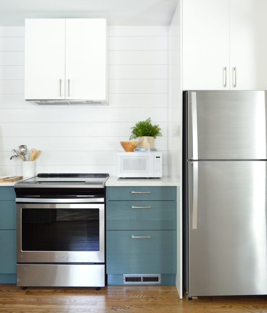 White Planked Wall Shiplap With Blue Ikea Cabinets