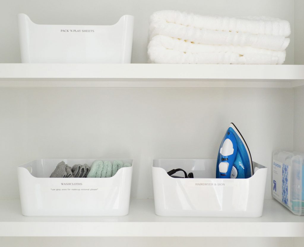 Labeled White Bins in Duplex Linen Closet